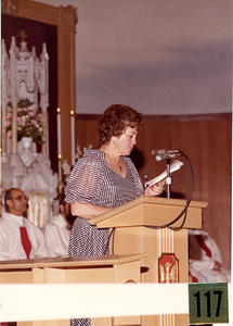 Woman speaking at mass