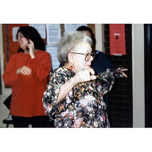 Older woman dancing at a social event.