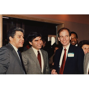 An unidentified man, Governor Dukakis (center), and Jorge Hernandez (right) pose for a picture during the opening of the Villa Victoria Cultural Center.