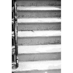 Stone steps with a decorative metal banister.