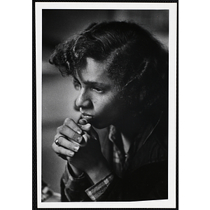 An African American girl from the Boys' Clubs of Boston facing left with her hands together