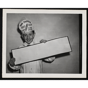 A member of the Tom Pappas Chefs' Club holds up a blank placard