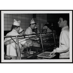 Members of the Tom Pappas Chefs' Club work the serving line in a Brandeis University dining hall