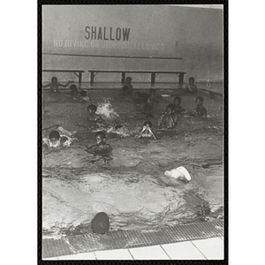 Boys swim in a natorium pool