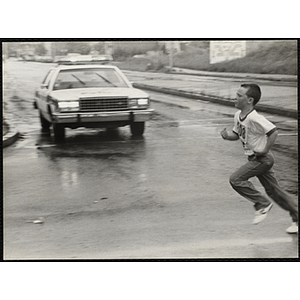 A boy runs in the Battle of Bunker Hill Road Race