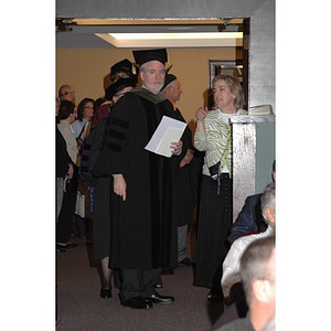 Faculty member speaks to usher at School of Nursing convocation