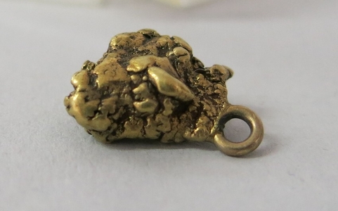 Gold nugget charm. Belonged to C. Malcolm Watkins' great grandmother Lura Burgess Thomas. Given to her by a relative who took part in the gold rush. United States, 1850-1880