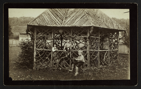 Group portrait of three children in a gazebo, location unknown, undated