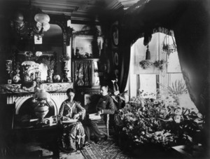 Double portrait of William and Mary Solomon, sitting in chairs in the parlor, William Solomon House, 3 Autumn St., Roxbury, Mass., ca. 1880