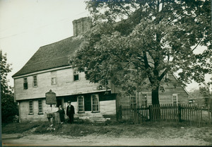 Exterior view of the Boardman House, with three people next to the Tercentenary historical marker, Saugus, Mass., undated