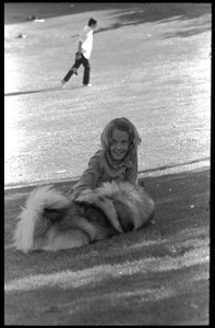 Young girl petting a dog on Cambridge Common