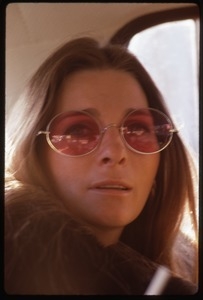 Judy Collins: portrait in rose-colored glasses, seated in the back of car
