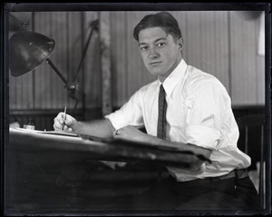 Percy Harding, seated at drafting table