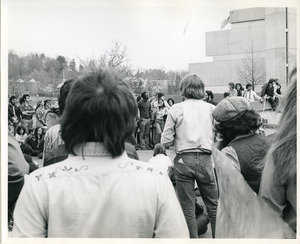 Board of Trustees fee increase demonstration: protestors listening to speaker, Whitmore Administration Building in background