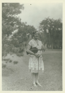 Elsie Averill standing outdoors with violin