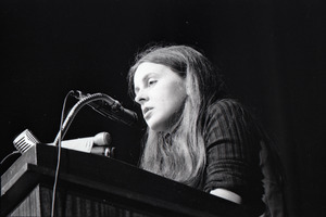Bernadette Devlin McAliskey at the podium during a talk at Northeastern University
