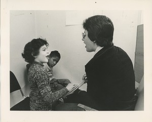 Speech therapist working with two children