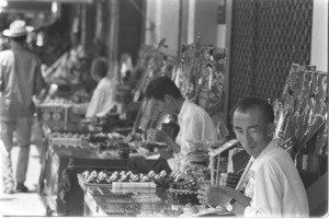 Every sidewalk is an open air market for small merchants; Saigon.