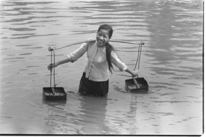 Girl taking water from river for cooking; Luong Hoa Village.