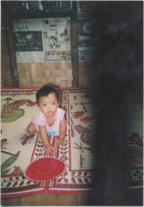 A photograph of So Meh's baby daughter in her home in Thailand, 2006
