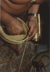 Basket Making: Em Yung nearly completes the bamboo ring of the basket, 1987