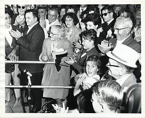 A group of unidentified men, women, and children