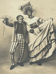 Jack Brown Stands in Drag Beside Dance Partner Charles Gregory with Arms Open Wide