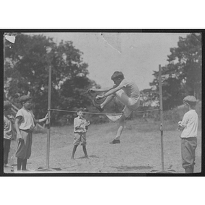 Youth doing high jump at Camp School, Allston