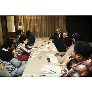 Meeting attendees seated around a table