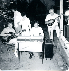 Victor Ares, Frankie Ares, and Henry Santos playing music outside