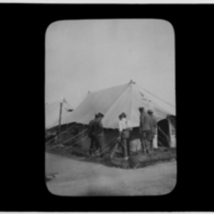 Men inspect a tent