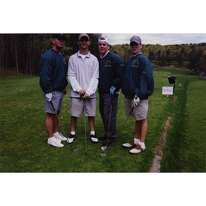 A four-man golf team posing on the golf course at the Charlestown Boys and Girls Club Annual Golf Tournament