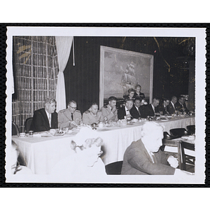 Several men sitting at a long table, including Tip O'Neill, on the far left, during the Kiwanis Club's Bunker Hill Postage Stamp Luncheon