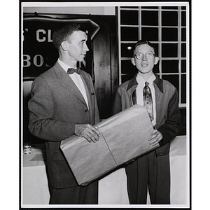 Charles Gaughan presents a gift to a boy at a Boys' Clubs of Boston Awards Night