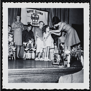 Miss Bunker Hill receives her sash at a Boys' Club Little Sister Contest