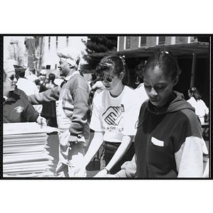 Several staff members working outside at the Boys and Girls Clubs of Boston 100th Anniversary Celebration Street Fair