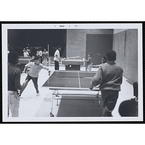 Boys play table tennis in a hall