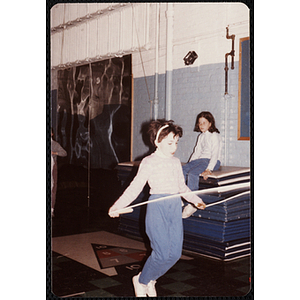 A girl swings a jump rope in front of her at the Charlestown gymnasium