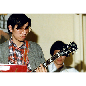 Musician performing at a Chinese Progressive Association party