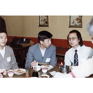 Members of the Chinese Progressive Association eat during a reception for the Consul General of Guangdong Province