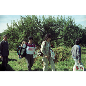 Suzanne Lee and others in an orchard on a Chinese Progressive Association trip