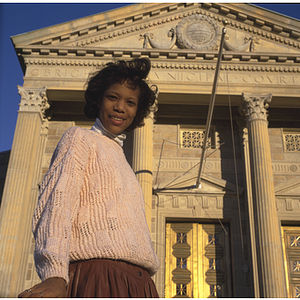 College of Criminal Justice co-op student standing in front of the Brighton Division, Boston Municipal Court Department