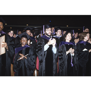 School of Law graduates standing and clapping at the commencement ceremony for the Class of 1982