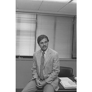 Law School professor Brook K. Baker on his desk