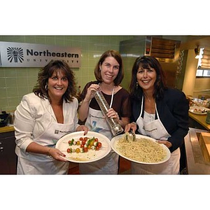 The chefs pose with their food at the Torch Scholars visit to the Exhibition Kitchen