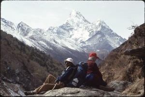 Guide K.P. Kafle (left) with Sandi Sommer (right) resting in shadow of Ama Dablam above Tengboche Monastery
