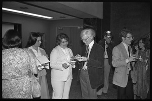 Andy Warhol signing autographs at a reception at the Birmingham Museum of Art