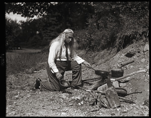 Albion L. Clough cooking at a campfire