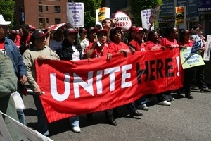 Marchers behind a banner reading 'Unite here!,' during the protest against the war in Iraq