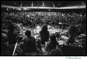 View from the stage of the audience in the Winterland Ballroom during the Ram Dass 'marathon,' looking over the band Amazing Grace